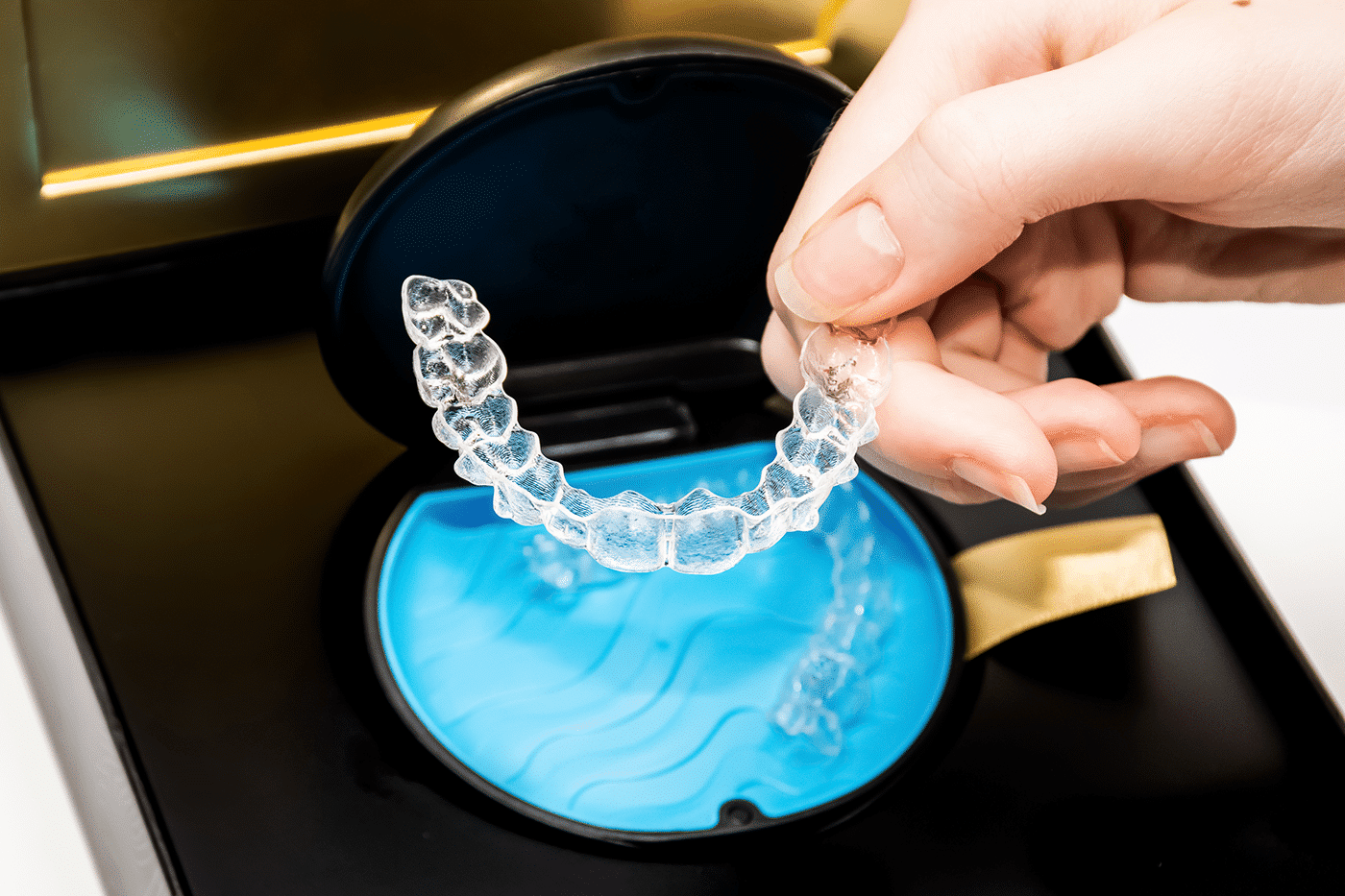 Clear Invisalign aligners displayed in their protective casing, highlighting their sleek design and secure storage